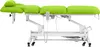 A bright green electric massage table with a white metal frame and wheels, shown against a white background. Náhled obrázku produktu