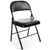 A black folding chair with a padded seat and backrest against a white background. Produktbild-Vorschau