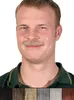 A man wearing a green polo shirt with a mustache. Produktbild-Vorschau