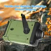 A green and black hand-crank emergency radio is placed on rocks with a blurred natural background. Produktbild-Vorschau