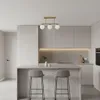 A modern kitchen with a central island and bar stools, featuring a gold chandelier. Náhľad obrázku produktu