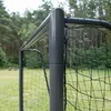 Close-up of a soccer goalpost and net in a grassy outdoor area with trees in the background. Produktbild-Vorschau