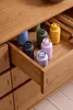 A collection of colorful spice grinders arranged in an open wooden drawer. Produktbild-Vorschau
