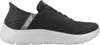 A side view of a gray Skechers slip-on shoe with a white sole. Anteprima dell’immagine prodotto
