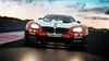 A racing car on a track during sunset. Produktbild-Vorschau