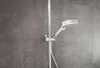 A close-up view of a shower head and rail against a textured gray wall. Produktbild-Vorschau