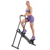 A woman is using a black and purple climber exercise machine against a white background. Podgląd zdjęcia produktu