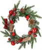 A Christmas wreath decorated with pinecones, red berries, and red baubles. Náhled obrázku produktu