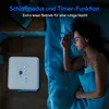 A woman sleeping peacefully in bed next to a white air conditioning unit. Produktbild-Vorschau