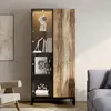 A display cabinet with glass doors and wooden accents, placed in a living room setting next to a sofa and armchair. Produktbild-Vorschau
