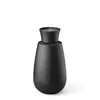A black aroma diffuser emitting a stream of vapor. Náhľad obrázku produktu