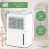 A white dehumidifier is shown in a room with a chair and a pillow. Dimensions and performance specifications are overlaid on the image. Podgląd zdjęcia produktu