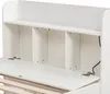 A close-up view of the open storage compartments and hinged shelf of a white bed frame. Produktbild-Vorschau