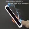 A hand holding a white and black rectangular object with lightning graphics around it. Produktbild-Vorschau