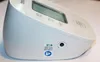A close-up side view of a white Omron blood pressure monitor, showing a sticker with model numbers and a small port. Náhľad obrázku produktu