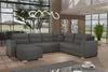 A spacious living room with a large sectional sofa, large windows, and modern decor. Produktbild-Vorschau
