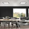 A modern dining and living area with a large window overlooking a garden. Produktbild-Vorschau