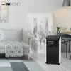 A modern living room with a sofa, a large abstract painting of a city skyline, and a mobile air conditioner. Voir les images du produit