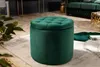 A dark green velvet ottoman is placed on a rug in a living room setting, with a sofa and other furniture visible in the background. Produktbild-Vorschau