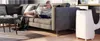 A woman relaxing on a couch using a tablet, with a portable air conditioner in the foreground. Produktbild-Vorschau
