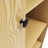 A close-up view of a wooden cabinet with a black handle and visible shelves. Produktbild-Vorschau