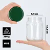A hand holding a green lid above a clear glass jar, with dimensions and weight information displayed. Produktbild-Vorschau