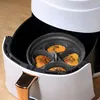A close-up shot of an air fryer insert with food inside. Produktbild-Vorschau