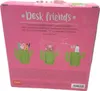 The image shows the back of a pink cardboard box packaging for a set of three ceramic cactus-shaped pen holders. The box has text and illustrations of the pen holders filled with various desk items. Voir les images du produit