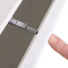 A finger presses on a white surface next to a gray mechanical part, likely demonstrating a push-to-open mechanism. Produktbild-Vorschau