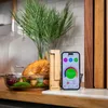 A cooked chicken and vegetables in a glass dish next to a Meater thermometer and a smartphone displaying the Meater app. Náhled obrázku produktu