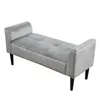 A gray velvet bench with armrests and tufted seating, shown from a side angle on a white background. Anteprima dell’immagine prodotto