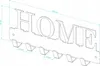 Technical drawing of a wall-mounted key holder with the word 'HOME' and dimensions indicated. Náhľad obrázku produktu