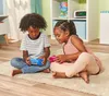 Two children are sitting on a rug, playing with toys. Podgląd zdjęcia produktu