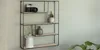 A wall shelf with decorative items on it, placed against a light-colored wall. Produktbild-Vorschau