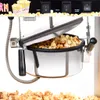 Close-up of a popcorn machine with popcorn inside and scattered around. Voir les images du produit