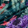 A close-up view of a fabric with a floral and leaf pattern. Produktbild-Vorschau