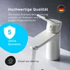 A white bathroom faucet with water running, set against a gray background, with marketing text and icons. Produktbild-Vorschau