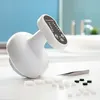 A white anti-cellulite massage device with a control panel is placed on a white surface, with small white cubes and black caps scattered in front of it. The background shows a blurred bathroom sink and faucet. Anteprima dell’immagine prodotto