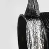 A close-up view of the inside of a flexible ventilation duct made of black plastic and silver foil. Produktbild-Vorschau