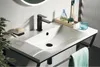 A modern bathroom sink with a black faucet and accessories. Anteprima dell’immagine prodotto