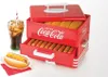A Coca-Cola branded hot dog steamer with hot dogs and buns inside, a glass of soda, and a prepared hot dog on a plate. Anteprima dell’immagine prodotto