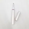 A white electric trimmer with a pink accent ring and its cap are placed on a textured white surface. Náhled obrázku produktu