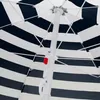 Close-up view of the underside of a striped umbrella, showing the central pole and mechanism. Voir les images du produit