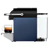 A side view of a Nespresso coffee machine with a cup of espresso. Produktbild-Vorschau