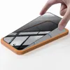 A hand is placing a screen protector onto a smartphone. Produktbild-Vorschau