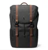 A black backpack with brown straps and buckles against a white background. Produktbild-Vorschau