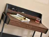 A close-up view of a minimalist desk with a magazine, keys, sunglasses, and a glass of drink. Náhled obrázku produktu