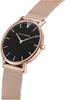 A close-up, angled view of a women's wristwatch with a black dial and rose gold case and mesh strap. Produktbild-Vorschau