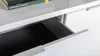 A close-up view of an open drawer in a white sideboard. Produktbild-Vorschau