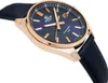 A close-up, angled view of a men's wristwatch with a blue dial and rose gold casing. Voir les images du produit